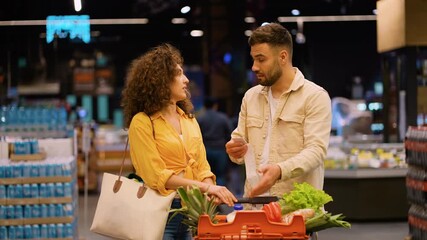 Couple discussing high food prices at supermarket
