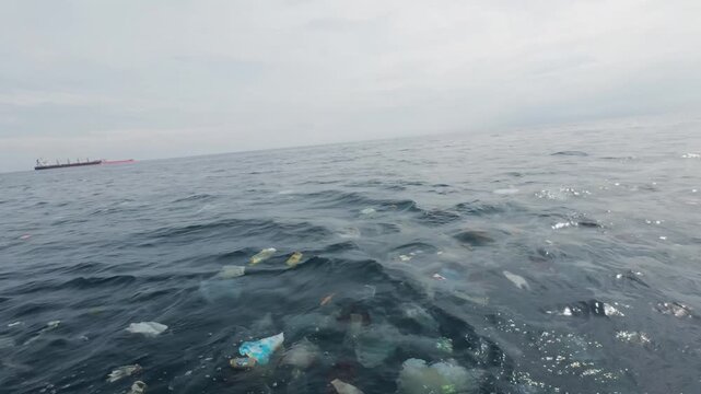 Trash is seen polluting the ocean. This trash is thought to have drifted and been carried by river currents to the sea. This will certainly disrupt the marine ecosystem and interfere with shipping.