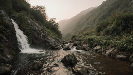 Serene Waterfall Cascading Through Lush Green Mountain Valley.