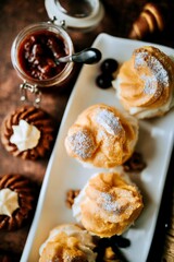 Cream puffs with jam and small pastries