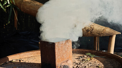 Smoke stacks from traditional charcoal production.