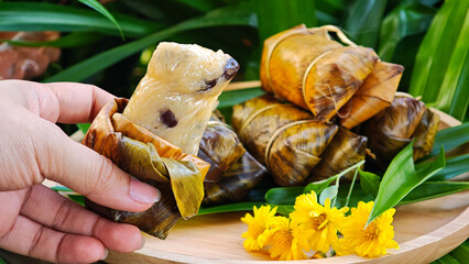 Sticky rice bananas (Khao Tom Mat or Khao Tom Pad) in hand, a traditional Thai dessert. © Chaaim