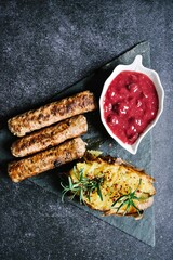 Sausages baked potato and sweet fruit topping plate