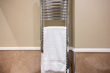 Interior European luxury hotel bathroom, fresh clean white bathmat on white claw foot tub, fresh...