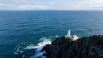 Lighthouse on Rocky Coast Overlooking Ocean.