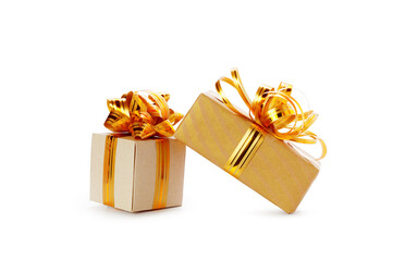 Golden ribbons  and Red color Christmas Gift Box white and golden lighting blur background
