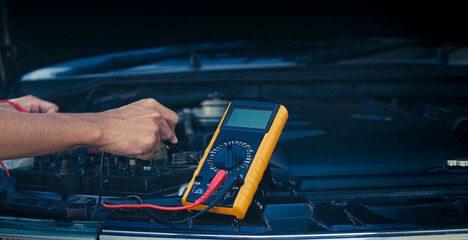 Auto mechanics use a multimeter to check the battery voltage.