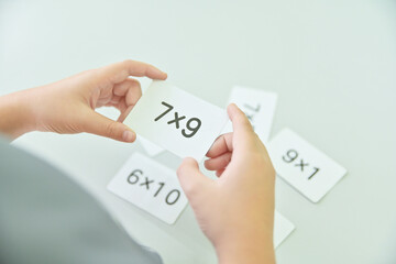 kid hold multiplicand in learning activity of holiday school