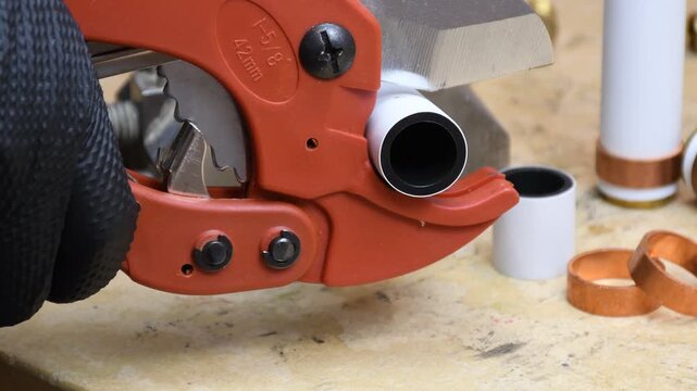 Cutting PEX piping. Ratchet plastic pipe cutter