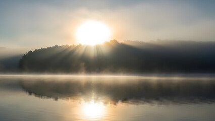 Beautiful morning sunrise reflection on the calm lake water under an orange and blue sky landscape