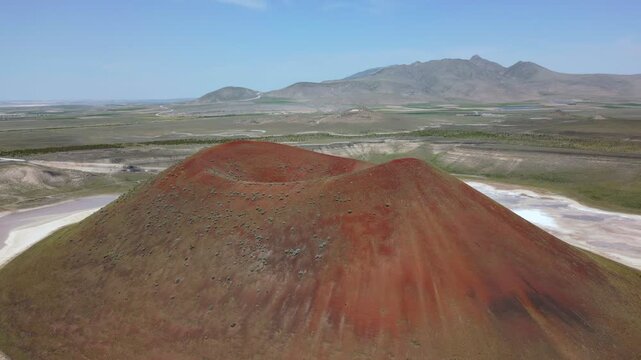 Drone aerial view of Lake Meke drying volcanic crater lake with red landscape in Turkey