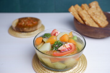 bowl of soup- vegetable and broth. soup with tomatoes, carrot, potatoes and leek. Italian vegetable soup minestrone made with a variety of vegetables