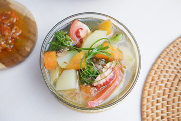 Chicken soup with vegetables in bowl. white background.  Top view.