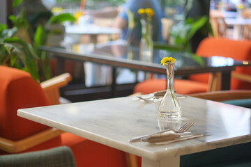 Table setup in a cafe with plants in the background