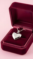 Elegant silver heart locket, subtly shining, nestled in an open luxurious red velvet box on a soft pink background, symbolizing love