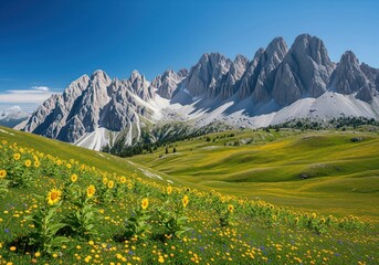 Panoramic view of rugged mountains and blooming meadow with sunflowers under clear sky