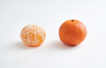 Whole and Peeled Mandarin Orange on White Background