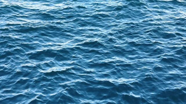 Blue sea surface with small waves and detailed natural texture