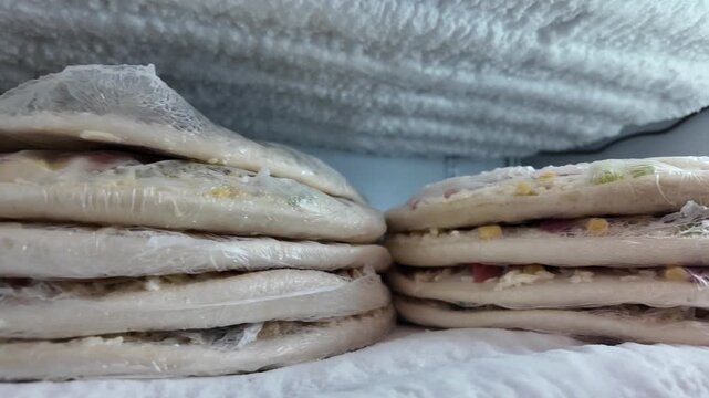 Baking dough rounds stored in refrigerator for pizza making