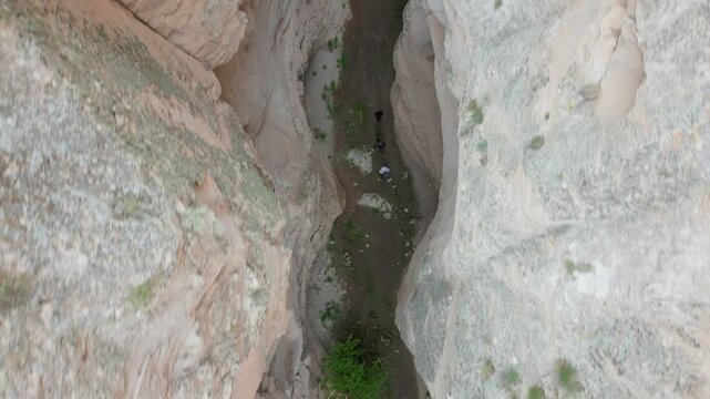 Tourists hiking Soganli canyon drone aerial view in Cappadocia, Turkey