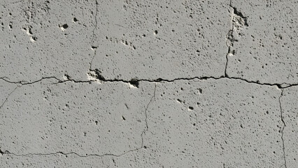 Fototapeta premium Cracked concrete surface with visible damage and wear