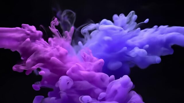 Abstract purple and blue ink clouds colliding and mixing in water against a black background, creating a fluid smoke effect for creative arts and chemistry concepts
