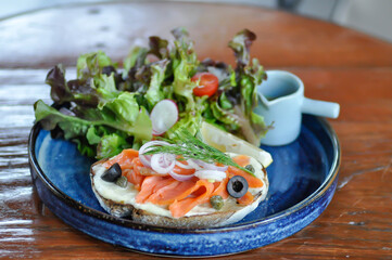 smoked salmon with bread and salad or salmon sandwich