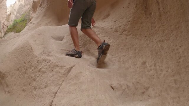 Man hiking rock formations in Soganli canyon in Cappadocia, Turkey