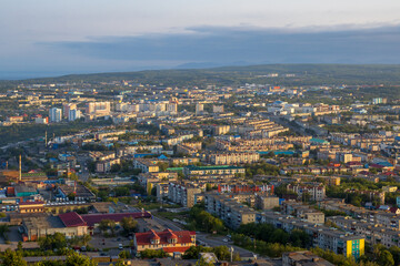Morning cityscape. Top view of the buildings and streets of the city. Residential urban areas at sunrise. Beautiful aerial city landscape. Petropavlovsk-Kamchatsky, Kamchatka Krai, Far East of Russia.