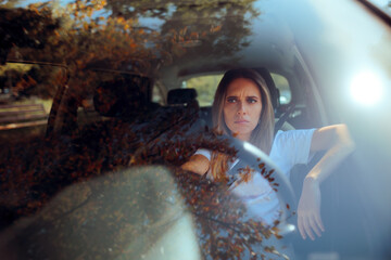 Worried Driver Sitting in her Car Feeling Stressed Out. Concerned woman feeling anxiety behind the wheel 
