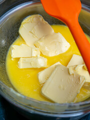 Melting Butter in Bowl: Double Boiler Method for Butter Preparation Cooking Process Infusion Close-up