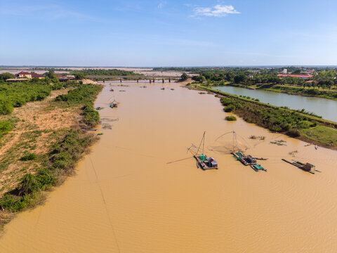 Fishermen and houses on a river, Kampong Cham province, Cambodia