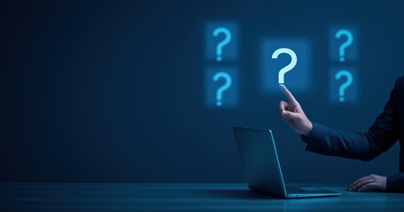 Business person pointing at question mark icons on screen with laptop for information and problem solving concepts and solutions