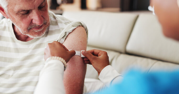 Caregiver, old man and arm in nursing home with bandage for flu vaccine, healthcare or wellness. Nurse, elderly person or help with plaster for immunity shot, medical safety or protection from virus. - Powered by Adobe