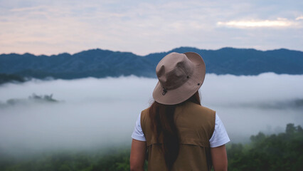 Rear view of a woman looking at the sea of fog and mountain views