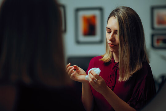 Woman using Wet Wipes to Clean her Hands. Person suffering from mysophobia  using antibacterial napkins 