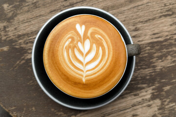 Hot coffee, a hot latte in a mug on a wooden table.