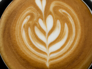 Hot coffee, a hot latte in a mug on a wooden table.
