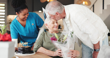 Senior couple, nurse and kiss with flowers for birthday or anniversary in retirement home together. Elderly, man and woman with caregiver, cake or floral bouquet for love, romance or celebration