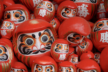 Traditional red Daruma doll used as a symbol of determination in Japanese culture at Katsuo-ji temple, Osaka, Japan