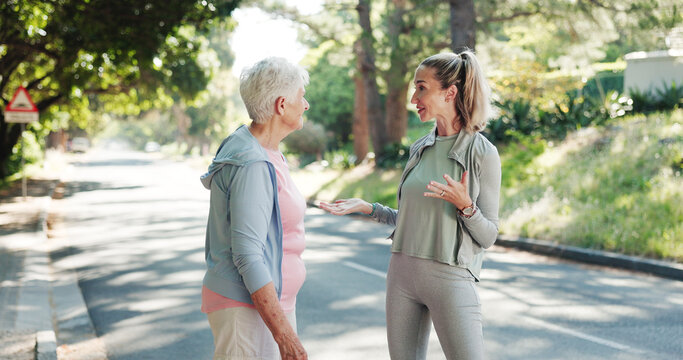 Senior, women or discussion with personal trainer in road for workout routine or exercise together. Elderly, female people or coach explaining tips for outdoor training, health or wellness in street - Powered by Adobe