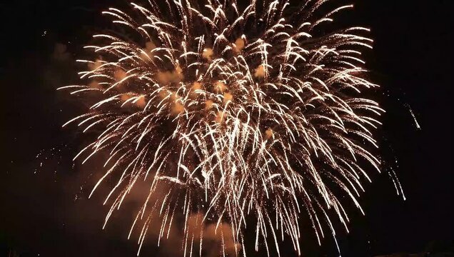 Fireworks explode in the night sky with colorful sparks and smoke Kembang Api