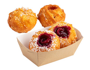 Golden fried donuts with powdered sugar and cherry filling in a cardboard tray.