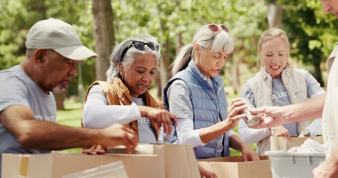 Volunteer, teamwork or packing boxes at park for food donation, charity event or community outreach. NGO project, senior group and woman with parcels in nature for activism, non profit and efficiency