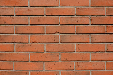 Close-up texture of a red brick wall showing detailed masonry and traditional construction pattern.