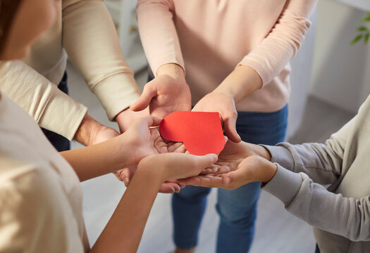 Red paper heart in hands, happy loving family, parents and children together, feeling care, emotionally and physically safe, support in family relationships, caring grateful people, close tender 