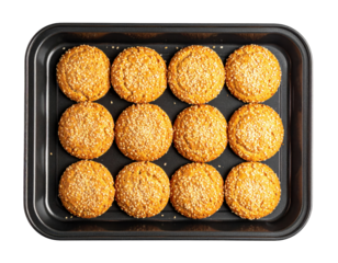 Twelve golden sesame seed cookies arranged neatly on a baking tray.