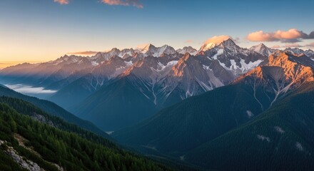 A majestic mountain range with snow-capped peaks and lush green valleys at sunset.