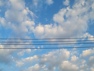 The sky is beautiful and the power poles.