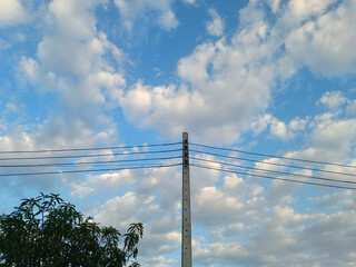 The sky is beautiful and the power poles.
